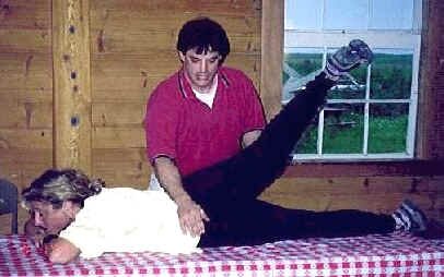 Therapist John Payne shows some stretching techniques on a participant.